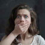 distressed woman with hand over her mouth-ways to ease menopause symptoms