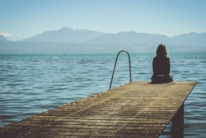 Sad girl staring into the water-reasons to lose weight